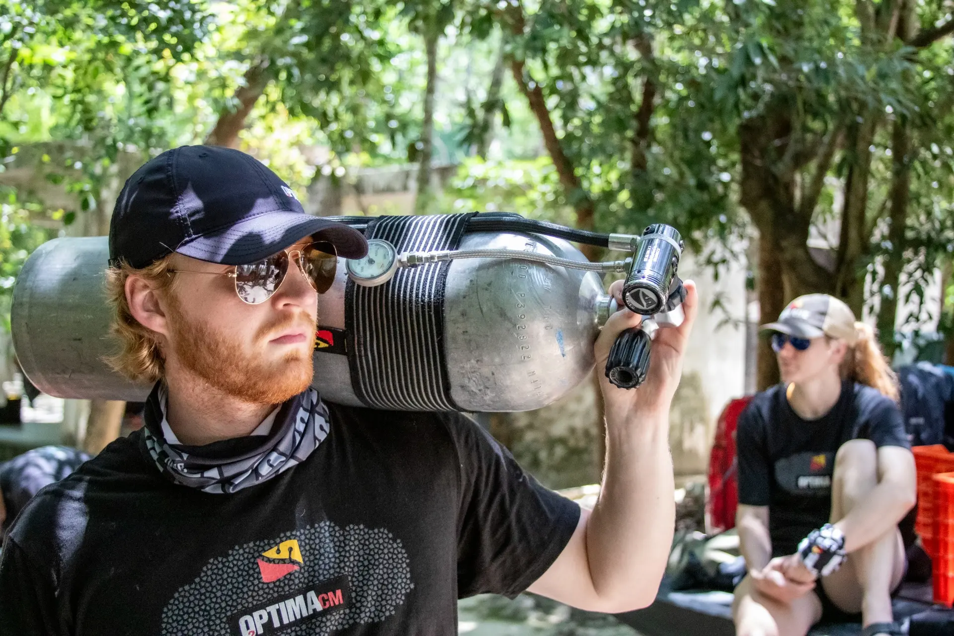 Team member preparing diving cylinders and gas equipment